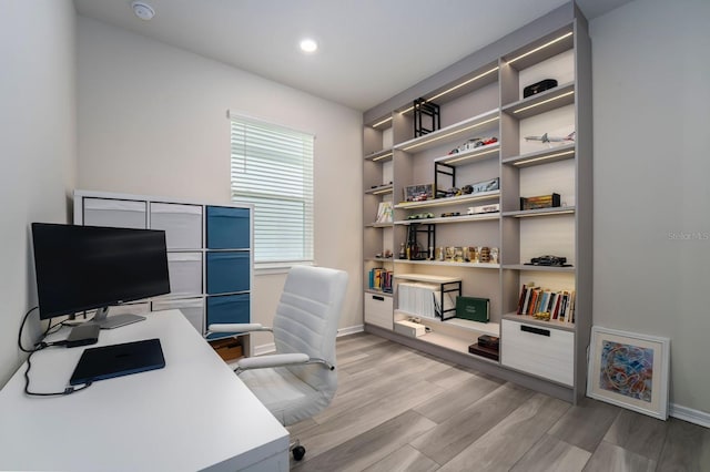 office space featuring light wood-style floors, recessed lighting, and baseboards