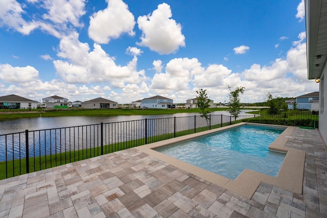 view of swimming pool featuring a water view, a fenced in pool, and a patio area