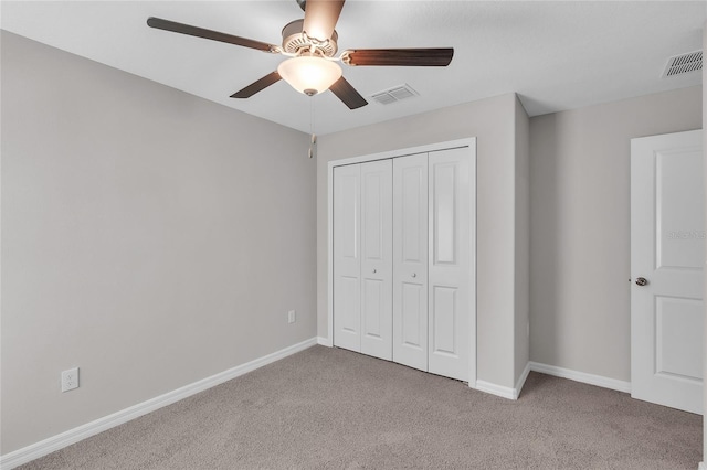 unfurnished bedroom featuring visible vents, carpet, and baseboards