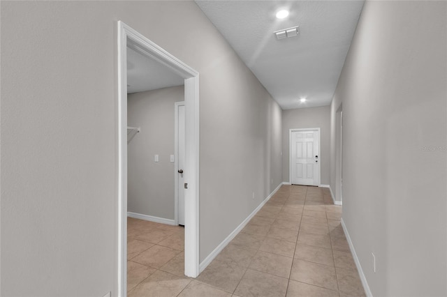 corridor featuring baseboards, recessed lighting, light tile patterned flooring, and visible vents