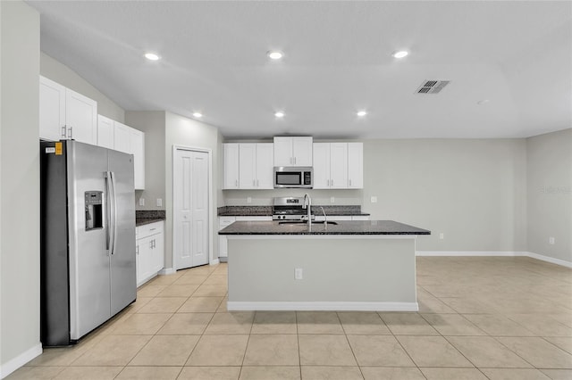 kitchen with visible vents, a sink, light tile patterned floors, and stainless steel appliances