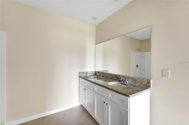 full bath featuring double vanity, a sink, a shower, and tile patterned floors