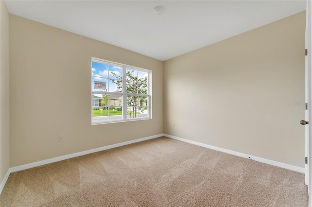 empty room with baseboards and carpet floors