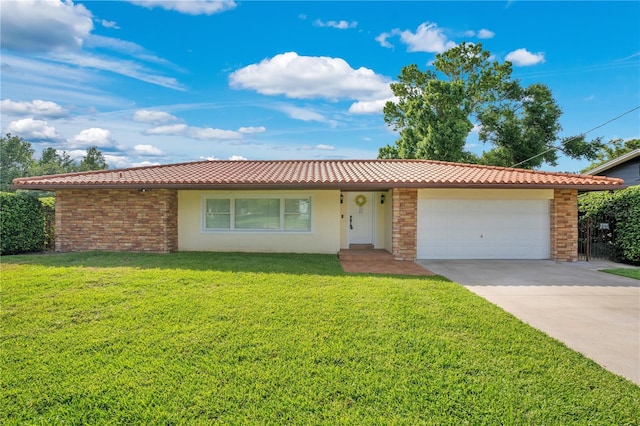 ranch-style house featuring an attached garage, a tile roof, stucco siding, a front yard, and concrete driveway