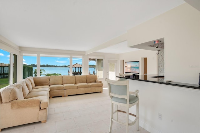 living area featuring baseboards and light tile patterned floors