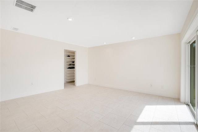 empty room featuring recessed lighting, visible vents, and light tile patterned flooring