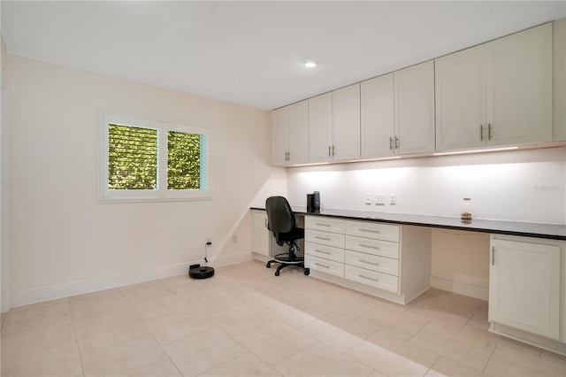 unfurnished office with baseboards and built in study area