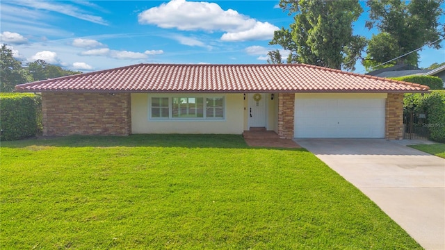 view of front of home with a tiled roof, driveway, and a front lawn