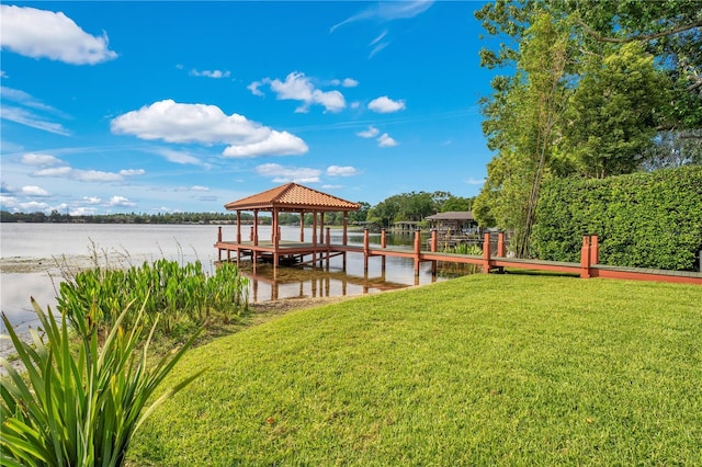 dock area featuring a lawn, a water view, and a gazebo