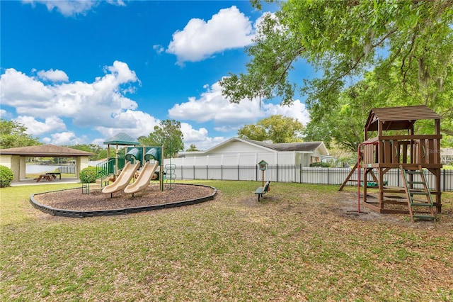 community playground with fence, a gazebo, and a lawn