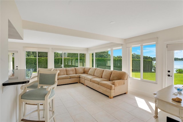 sunroom with baseboards and tile patterned flooring