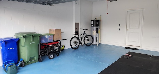 garage with heat pump water heater and concrete block wall