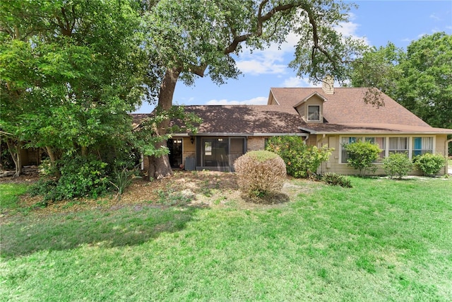 view of front of house with a front lawn and a chimney