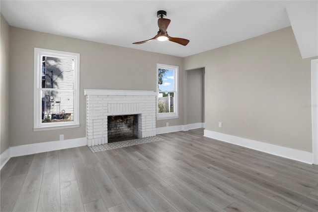 unfurnished living room with baseboards, ceiling fan, and wood finished floors