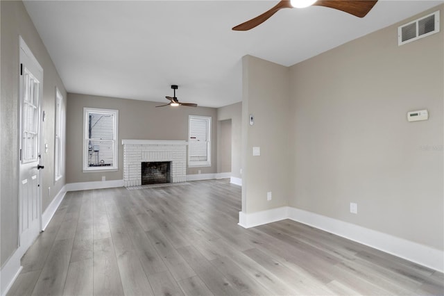 unfurnished living room with baseboards, ceiling fan, light wood-style flooring, and visible vents