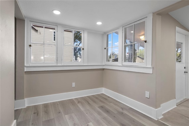 unfurnished dining area featuring baseboards, recessed lighting, and light wood-style flooring