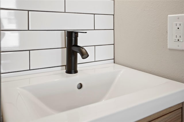 room details featuring a sink and a textured wall