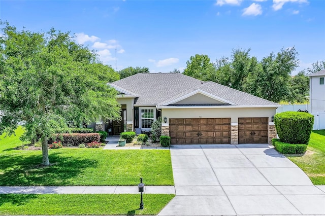 view of front of home featuring an attached garage, a front lawn, stone siding, stucco siding, and concrete driveway