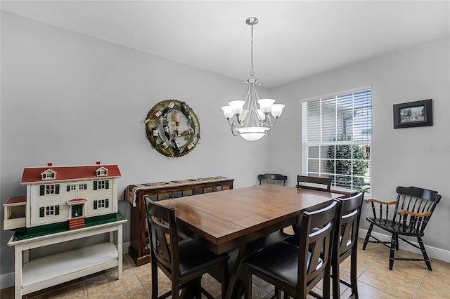 dining area with baseboards and a notable chandelier