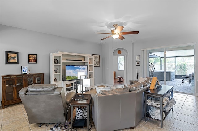 living room with light tile patterned flooring, ceiling fan, and visible vents
