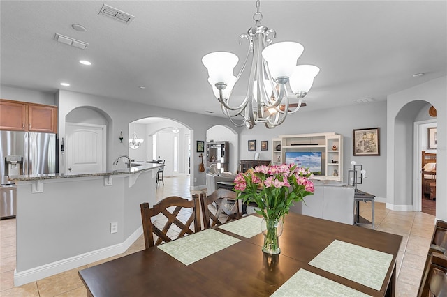 dining area featuring visible vents, recessed lighting, a chandelier, arched walkways, and light tile patterned floors