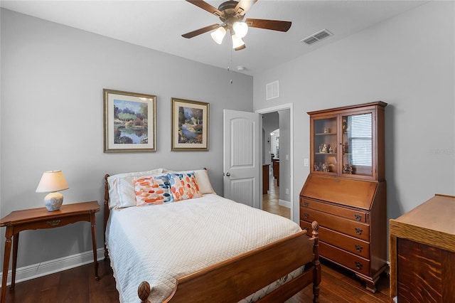 bedroom with baseboards, wood finished floors, and visible vents