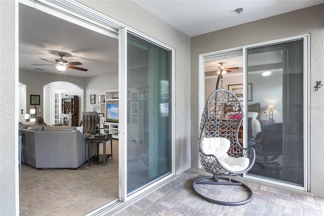 exterior space with ceiling fan