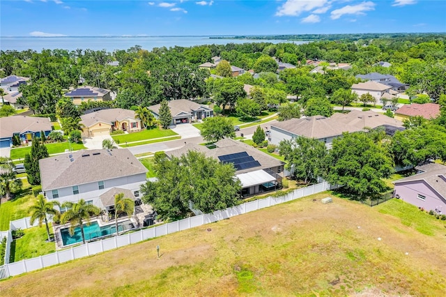 drone / aerial view with a water view and a residential view