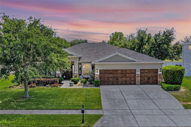 721 Lake Cove Pointe Cir, Winter Garden, FL 34787 - view of front facade with an attached garage, a front lawn, concrete driveway, and stone siding