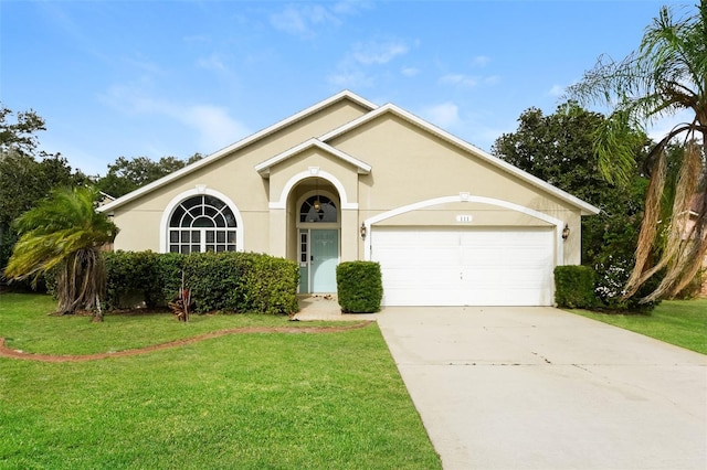 ranch-style home featuring driveway, stucco siding, a front lawn, and a garage