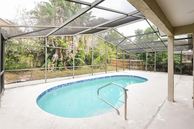 view of swimming pool featuring a patio, glass enclosure, a fenced backyard, and a fenced in pool