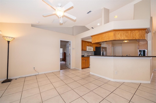 2924 Jebidiah Loop, Saint Cloud, FL 34772 - kitchen with white microwave, black refrigerator with ice dispenser, dark countertops, ceiling fan, and light tile patterned flooring