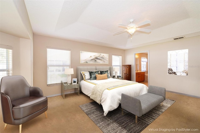 2924 Jebidiah Loop, Saint Cloud, FL 34772 - bedroom featuring carpet flooring, baseboards, a raised ceiling, ensuite bathroom, and a ceiling fan