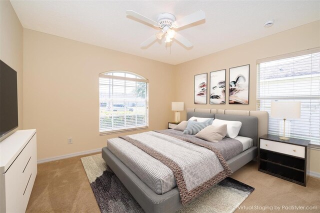 2924 Jebidiah Loop, Saint Cloud, FL 34772 - bedroom featuring light colored carpet, multiple windows, baseboards, and a ceiling fan