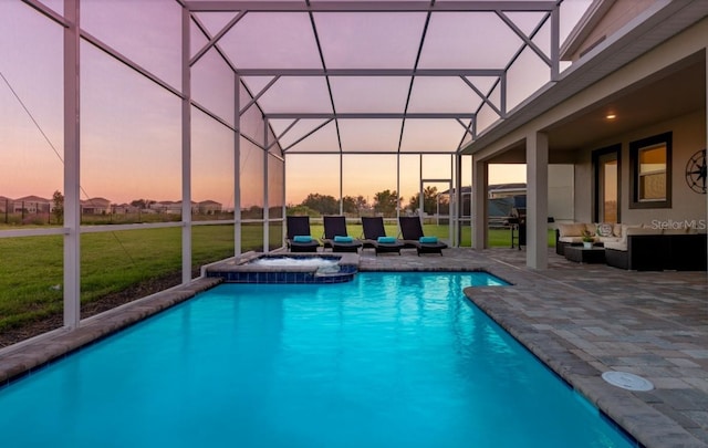 view of pool with an outdoor hangout area, a patio, a yard, and glass enclosure