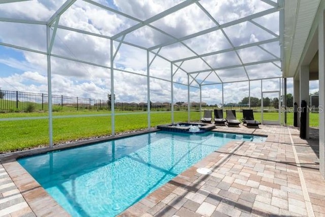 view of swimming pool featuring a yard, a patio area, glass enclosure, and a pool with connected hot tub