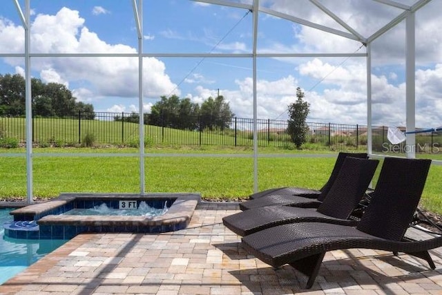 view of patio / terrace featuring a fenced backyard, an in ground hot tub, a lanai, and a fenced in pool