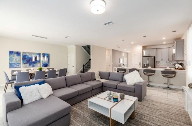living area with stairway, visible vents, and recessed lighting