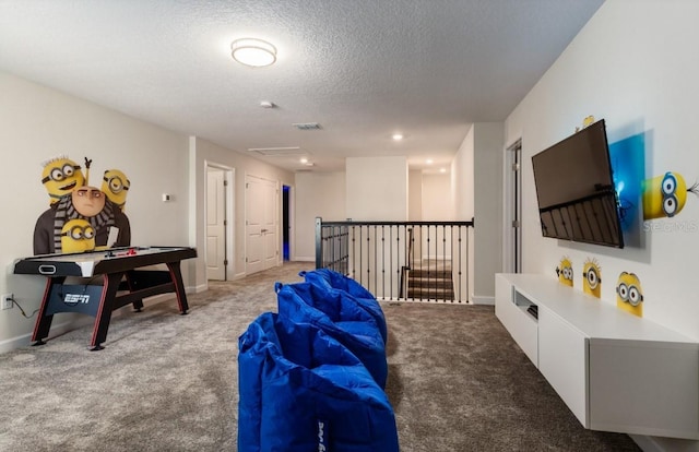 carpeted living area with a textured ceiling, baseboards, and visible vents