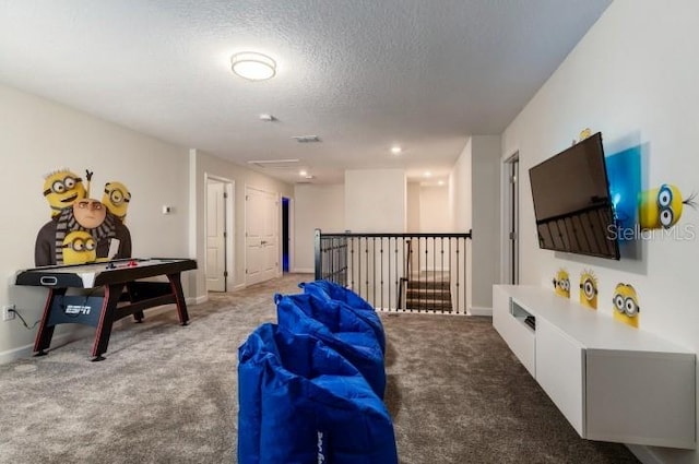 living area featuring a textured ceiling, baseboards, and light colored carpet