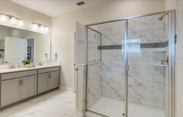 full bathroom featuring a sink, marble finish floor, visible vents, a shower stall, and double vanity