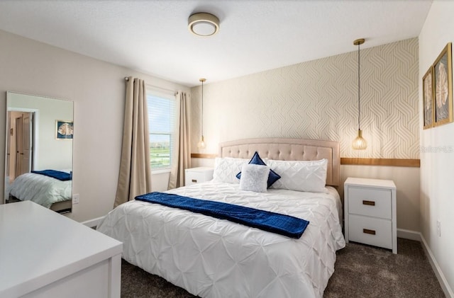 bedroom featuring baseboards and dark colored carpet
