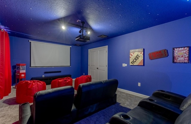 cinema room featuring a textured ceiling, visible vents, baseboards, and carpet floors