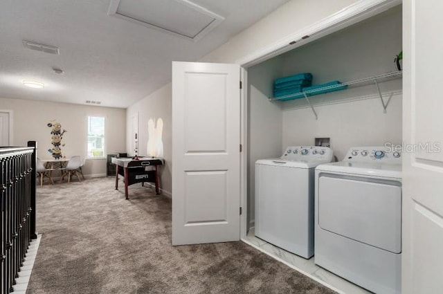 laundry room with laundry area, attic access, carpet, visible vents, and washer and dryer
