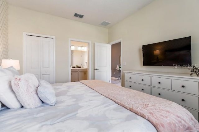 bedroom featuring connected bathroom, a closet, and visible vents