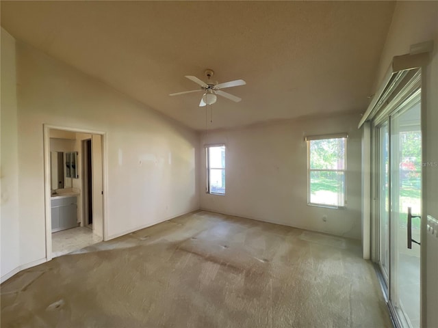 6042 Wade St, Leesburg, FL 34748 - spare room with a ceiling fan, lofted ceiling, and light carpet