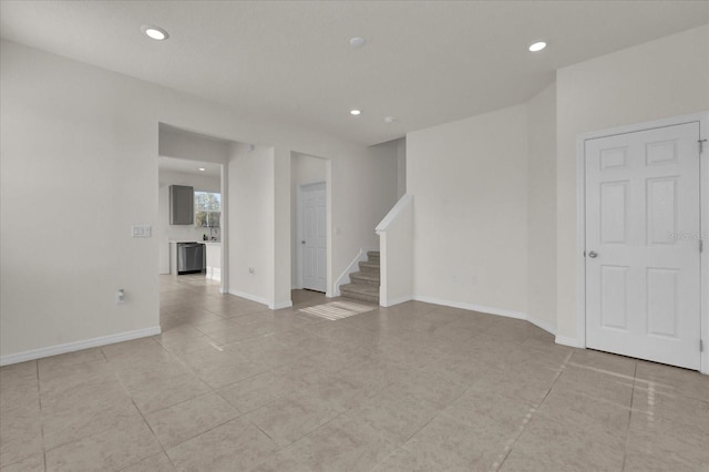 empty room featuring recessed lighting, light tile patterned flooring, stairway, and baseboards