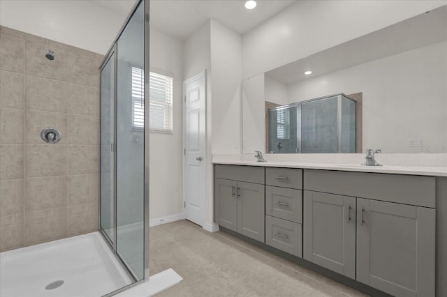full bath with recessed lighting, double vanity, a sink, and a shower stall