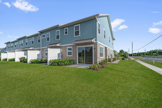 back of property with a yard