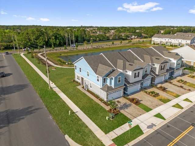birds eye view of property featuring a water view and a residential view